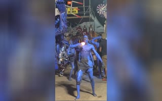 Carnival Blue Man Just Became Redman After Spitting Fire... all over Himself and Everybody Else