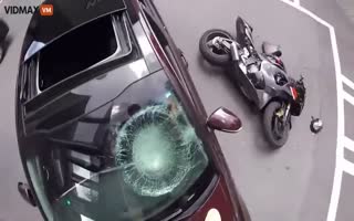 Speeding Motorcyclist Crashes Into Car Making An Illegal Turn, Biker Ends Up On Hood, Kicks In Windshield
