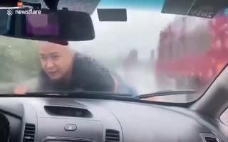 Chinese Man Clings to the Hood of His Ex-Wifes Car as She Speeds up a Rainy Highway