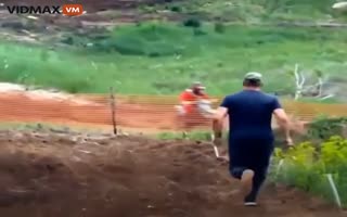 Russian Dad Runs Onto an Active Race Track to Kick and Punch His Own Kid Who's Motorcycle Stalled