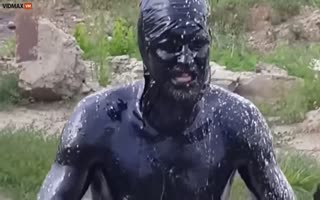 Russian Idiot Jumps Into a Pool of Oil, FREAKS When It Won't Come Off and Starts Burning