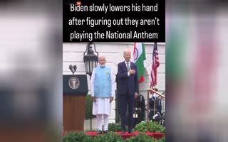 Fake Pres. Joe Biden Slowly Moves His Hand Away as He Realizes Its NOT The National Anthem of the USA Playing