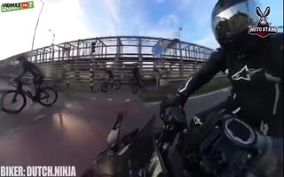 Motorcyclist Blows Through a Red Light and Clips a Cyclist, Sends Him Flying