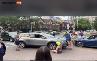 Car Slowly Pushes Annoying Protester Blocking The Road Out Of The Way In Toronto, Now He's Under Investigation