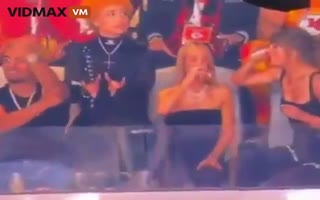 Watch As Role Model Taylor Swift Chugs Beers At The Superbowl As Her Buddy Ice Spice Makes Satanic Gestures While Wearing An Upsidedown Cross