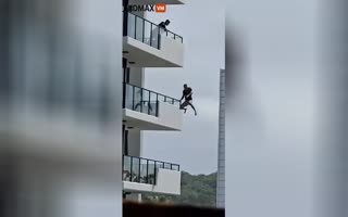 WILD FOOTAGE: Man Jumps From 5th Floor Into Swimming Pool To Evade Arrest